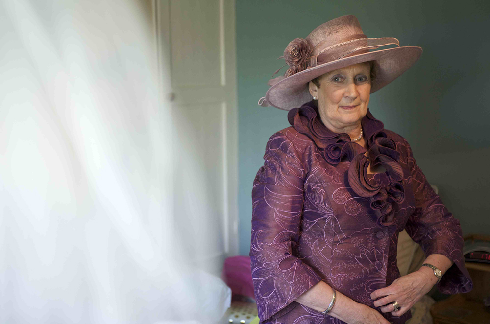 The brides mother looking adoringly at the bride by cambridge photographer Richard Bowring