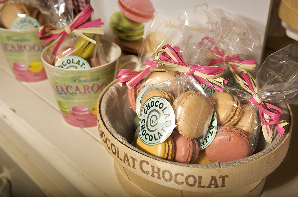Three containers of macaroons made by the cambridge company chocolat chocolat