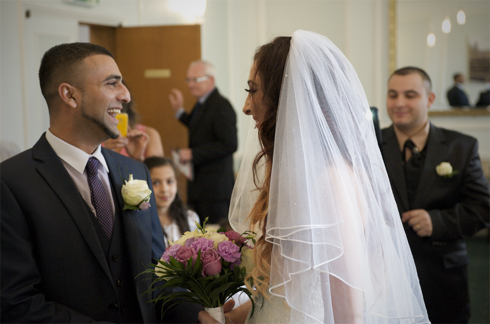 The bride and Groom laugh during the wedding ceremony of Adnan and Jasmina by Cambridge photographer Richard Bowring